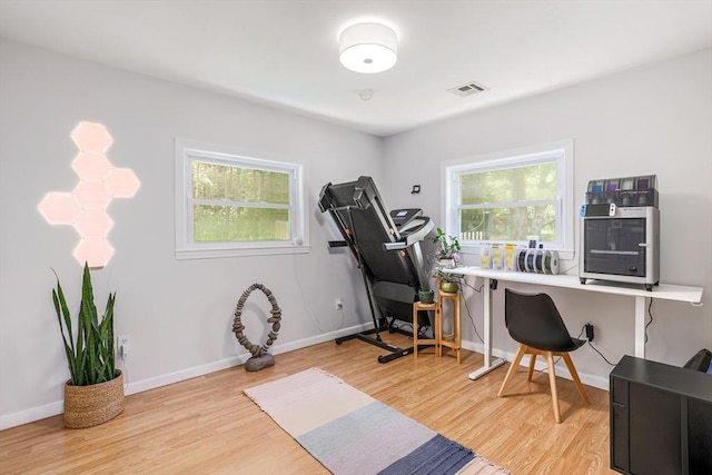128 Clinton St, Hopkinton, MA 01748 - workout room with healthy amount of natural light, wood finished floors, and baseboards