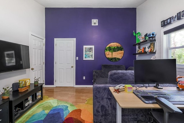 128 Clinton St, Hopkinton, MA 01748 - office area with a towering ceiling, wood finished floors, and baseboards