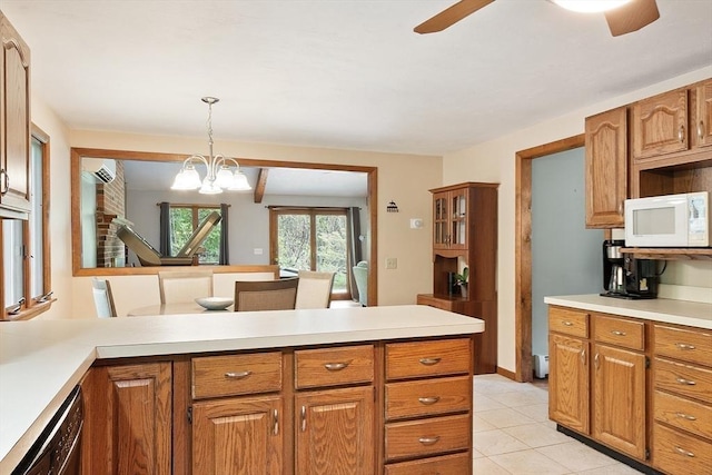 25 Williams Rd, Fitchburg, MA 01420 - kitchen featuring white microwave, a wall unit AC, light countertops, a ceiling fan, and a peninsula
