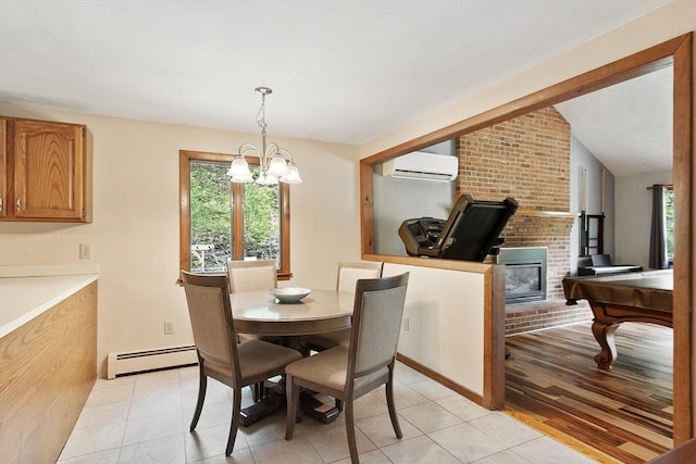25 Williams Rd, Fitchburg, MA 01420 - dining space featuring a baseboard radiator, a wall mounted air conditioner, a chandelier, lofted ceiling, and light tile patterned floors