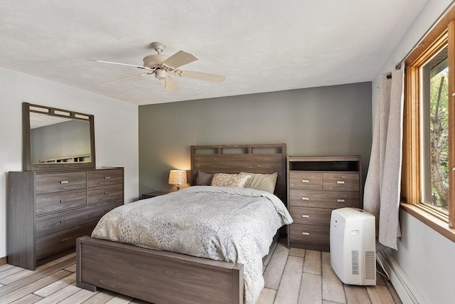 25 Williams Rd, Fitchburg, MA 01420 - bedroom featuring light wood finished floors, baseboard heating, ceiling fan, and baseboards