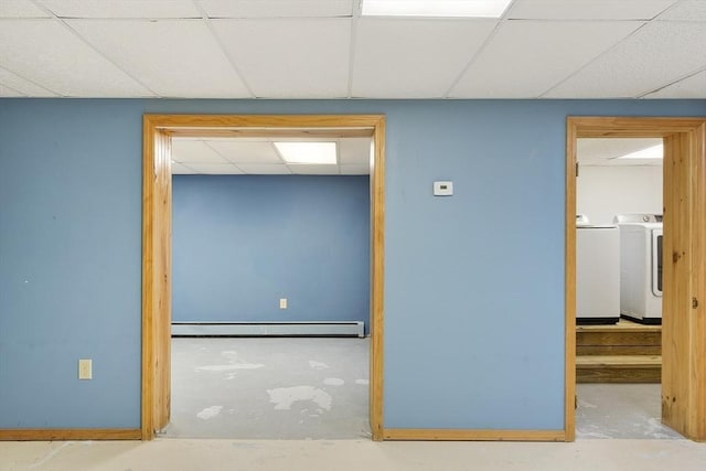 25 Williams Rd, Fitchburg, MA 01420 - unfurnished room with a baseboard radiator, washer and clothes dryer, a paneled ceiling, and concrete floors
