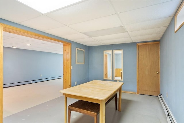 25 Williams Rd, Fitchburg, MA 01420 - dining space with a baseboard heating unit, concrete flooring, and a paneled ceiling