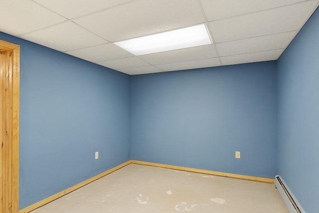 25 Williams Rd, Fitchburg, MA 01420 - empty room featuring a baseboard heating unit, baseboards, a drop ceiling, and concrete floors