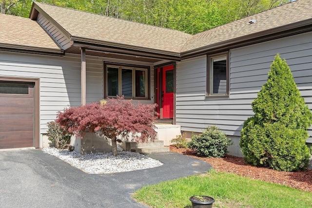 25 Williams Rd, Fitchburg, MA 01420 - doorway to property featuring a shingled roof, covered porch, and an attached garage