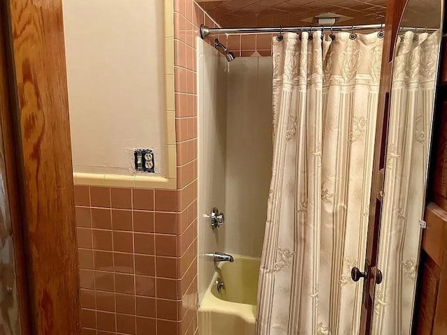 bathroom with shower / bath combo with shower curtain