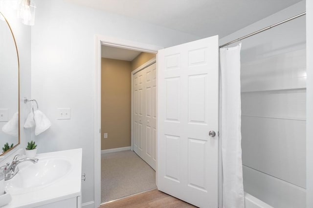 22 Mountain Brook Rd, Sturbridge, MA 01566 - bathroom with vanity, shower / tub combo with curtain, wood finished floors, and baseboards