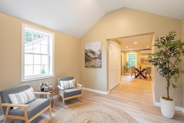 22 Mountain Brook Rd, Sturbridge, MA 01566 - living area with light wood-type flooring, lofted ceiling, a wall mounted AC, baseboards, and recessed lighting