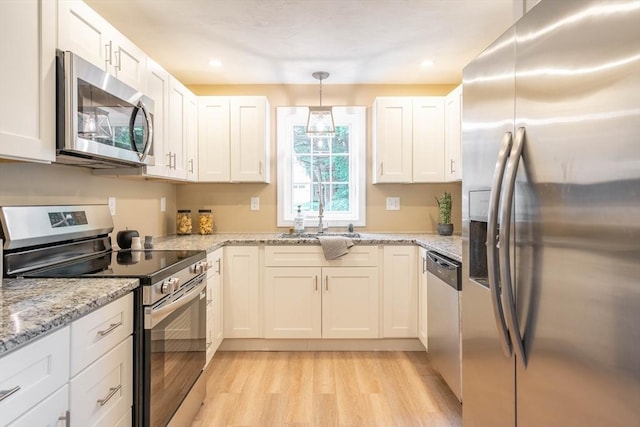 22 Mountain Brook Rd, Sturbridge, MA 01566 - kitchen featuring stainless steel appliances, a sink, light wood-type flooring, white cabinetry, and recessed lighting