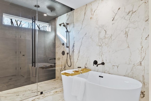 bathroom featuring tile walls and independent shower and bath