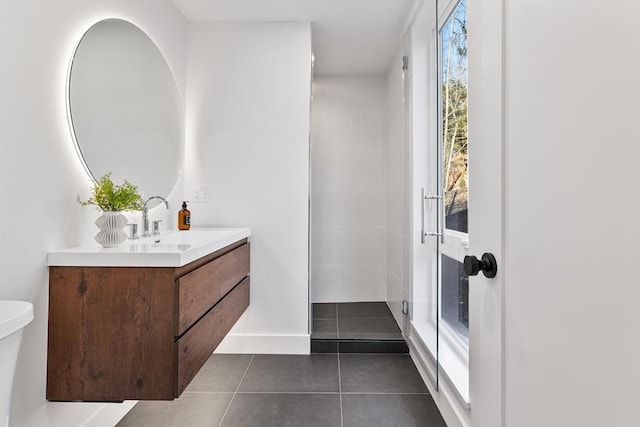 bathroom with vanity, a shower, tile patterned flooring, and toilet