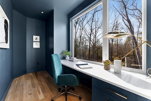 office area featuring built in desk and hardwood / wood-style flooring