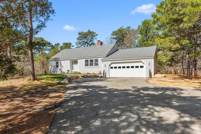 30 Grannys Ln, Orleans, MA 02653 - view of front of property with a chimney, a garage, and aphalt driveway