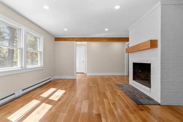 30 Grannys Ln, Orleans, MA 02653 - unfurnished living room featuring a baseboard heating unit, baseboards, light wood-style flooring, and a fireplace
