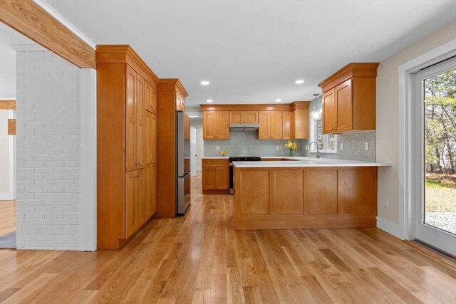 30 Grannys Ln, Orleans, MA 02653 - kitchen with stainless steel appliances, light countertops, a peninsula, and under cabinet range hood