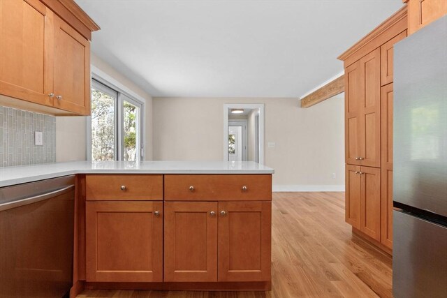 30 Grannys Ln, Orleans, MA 02653 - kitchen featuring light wood-style flooring, a peninsula, stainless steel appliances, and light countertops