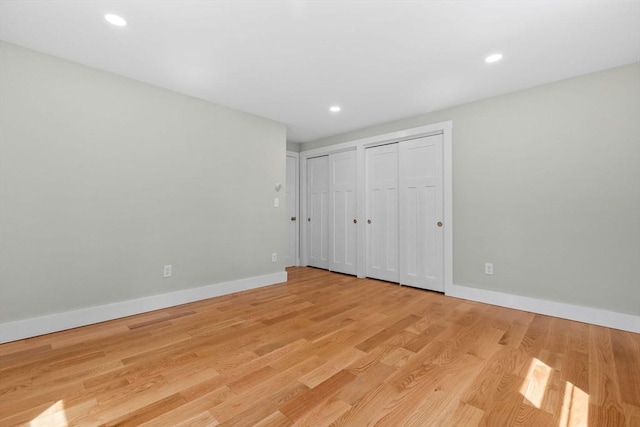30 Grannys Ln, Orleans, MA 02653 - unfurnished bedroom featuring baseboards, recessed lighting, light wood finished floors, and multiple closets