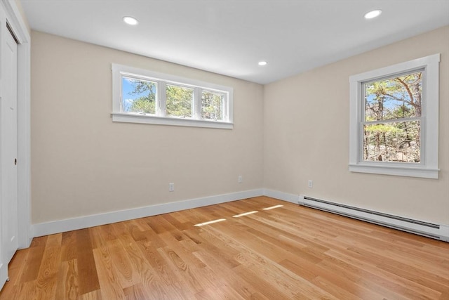 30 Grannys Ln, Orleans, MA 02653 - unfurnished bedroom featuring baseboards, multiple windows, a baseboard radiator, and light wood-style floors