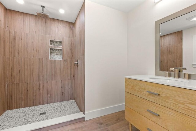 30 Grannys Ln, Orleans, MA 02653 - bathroom featuring recessed lighting, wood finished floors, a tile shower, vanity, and baseboards