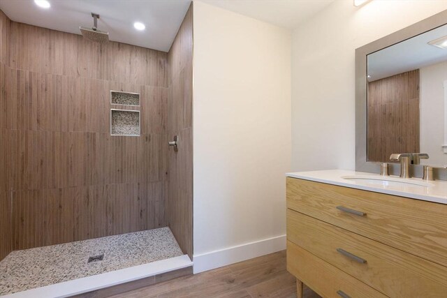 30 Grannys Ln, Orleans, MA 02653 - bathroom with vanity, tiled shower, wood finished floors, and baseboards