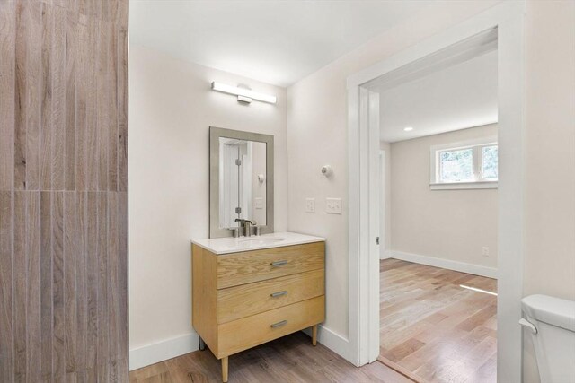 30 Grannys Ln, Orleans, MA 02653 - bathroom with toilet, wood finished floors, vanity, and baseboards