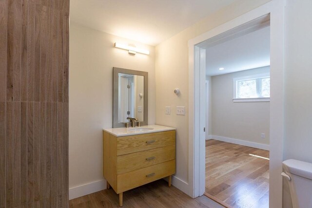 30 Grannys Ln, Orleans, MA 02653 - bathroom with toilet, wood finished floors, vanity, and baseboards