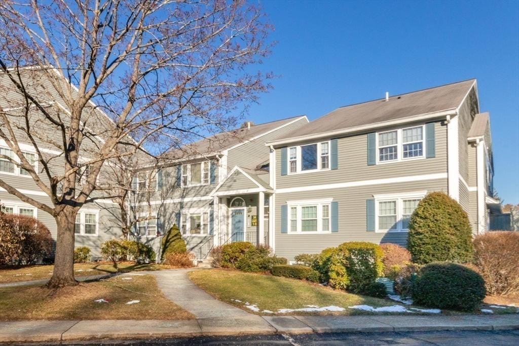 colonial-style house with a front lawn