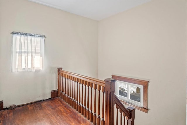 stairs featuring hardwood / wood-style floors