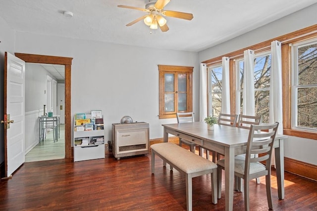 dining room with ceiling fan and dark hardwood / wood-style floors