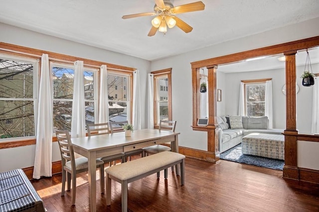 dining space featuring ceiling fan, dark hardwood / wood-style flooring, and decorative columns