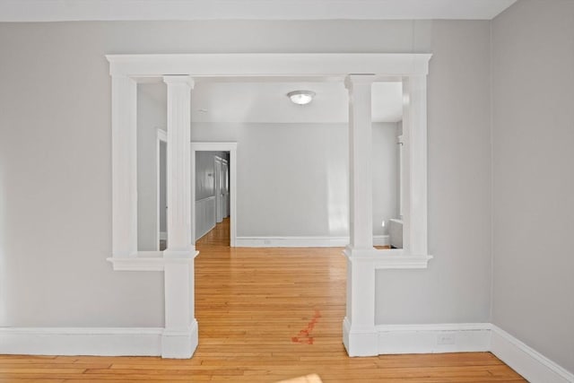 hall featuring hardwood / wood-style flooring and ornate columns