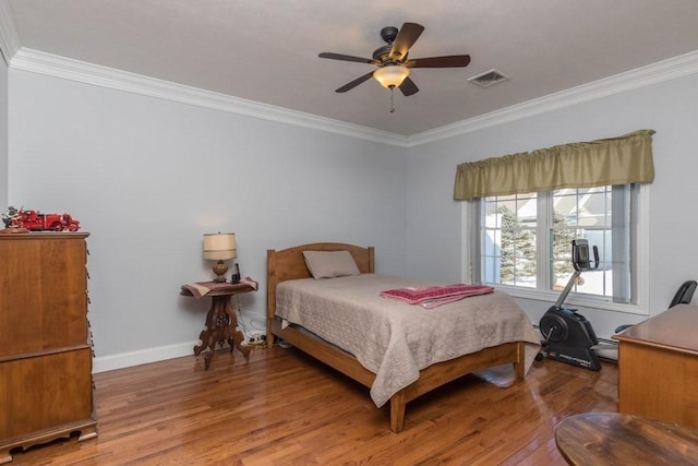 bedroom with ornamental molding, hardwood / wood-style floors, and ceiling fan