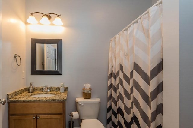 bathroom featuring vanity, toilet, and a shower with shower curtain