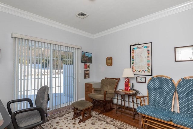 sitting room with crown molding, a baseboard radiator, and light hardwood / wood-style flooring