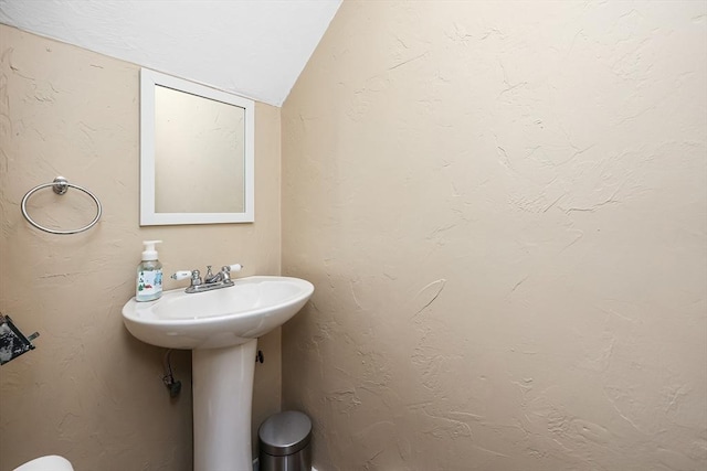 bathroom featuring sink and vaulted ceiling