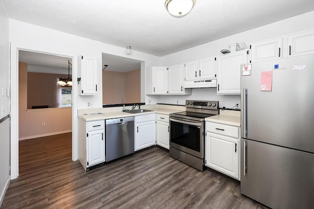 kitchen featuring white cabinetry, sink, dark hardwood / wood-style flooring, a notable chandelier, and appliances with stainless steel finishes