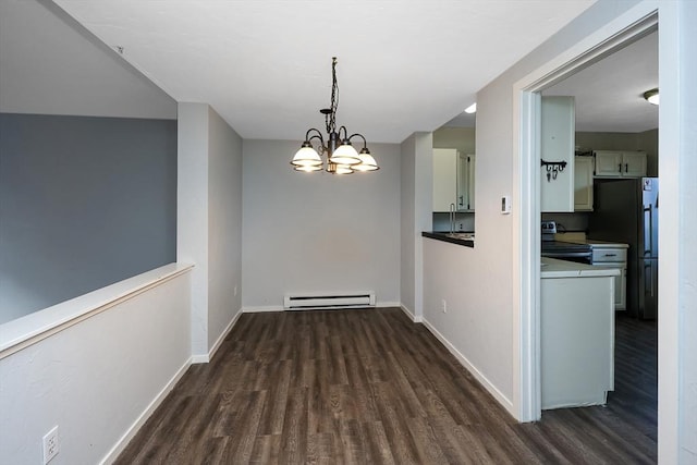 unfurnished dining area featuring a chandelier, dark hardwood / wood-style floors, and a baseboard heating unit