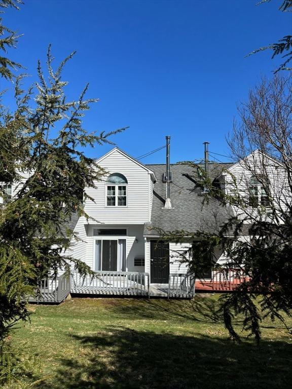 back of property featuring a yard and a deck