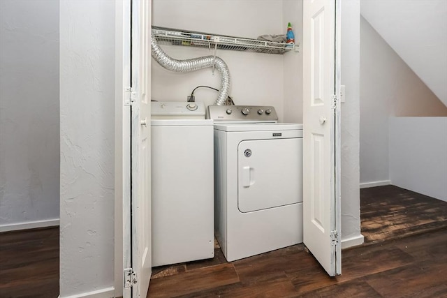 laundry room with washing machine and dryer and dark wood-type flooring