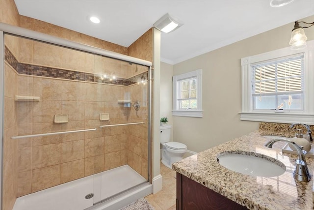 full bath with toilet, a sink, tile patterned flooring, and a stall shower
