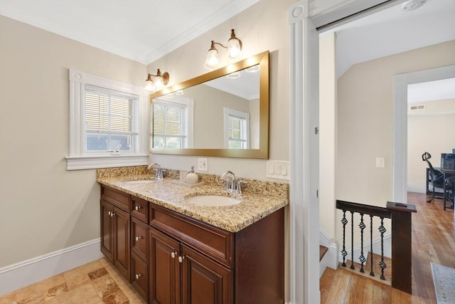 full bathroom featuring visible vents, a sink, crown molding, and double vanity
