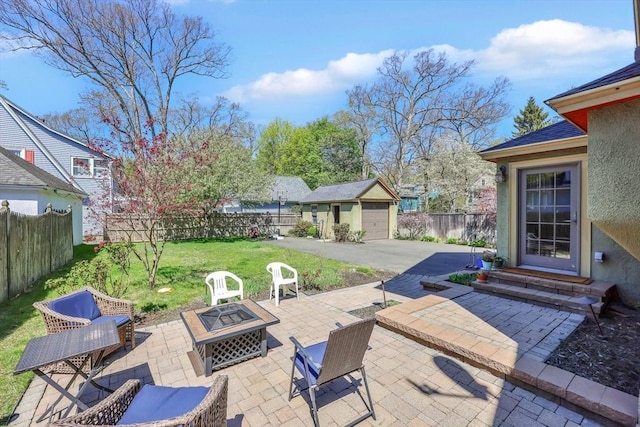 view of patio featuring a fenced backyard, a fire pit, an outbuilding, and entry steps