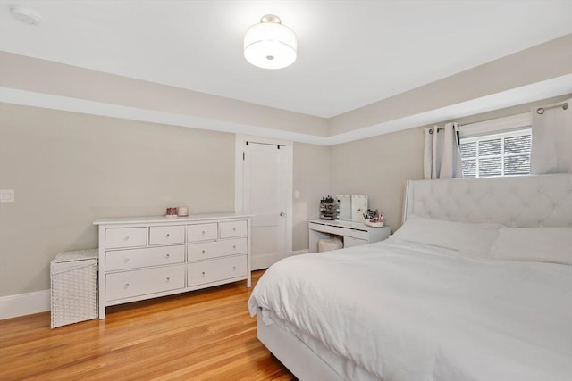 bedroom with baseboards and light wood-type flooring