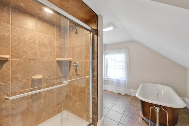 full bath featuring tile patterned flooring, a soaking tub, vaulted ceiling, and a stall shower