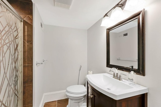 bathroom featuring visible vents, tile patterned floors, toilet, and vanity