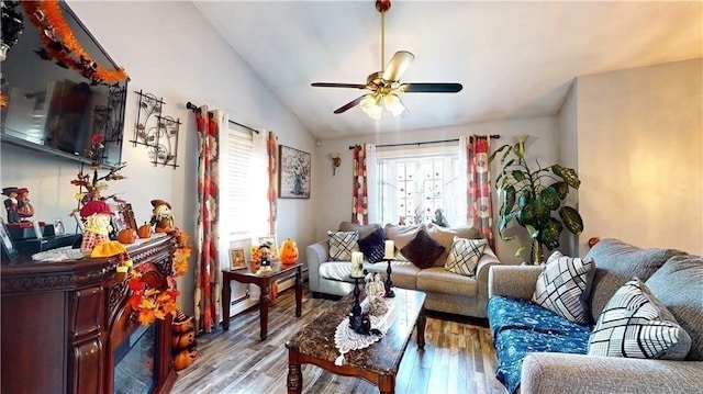 living room featuring light wood-type flooring, vaulted ceiling, and ceiling fan