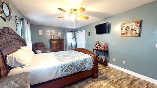 bedroom with a closet, ceiling fan, and hardwood / wood-style floors