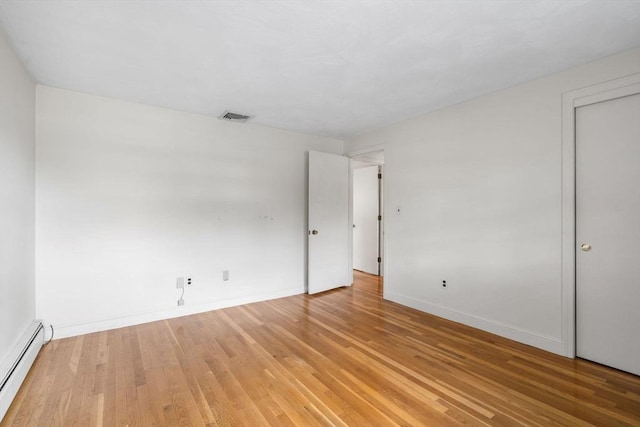 3 Biggar Ave, Wilmington, MA 01887 - empty room with a baseboard heating unit, light wood-style flooring, and baseboards