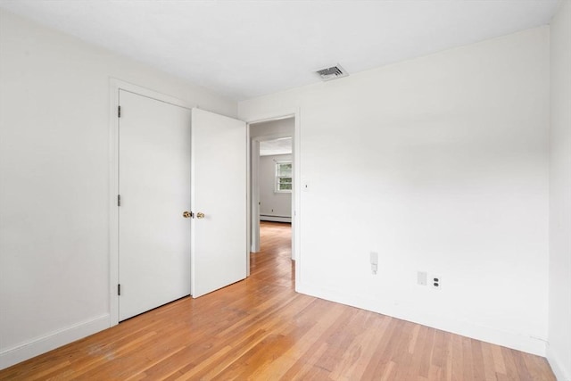 3 Biggar Ave, Wilmington, MA 01887 - unfurnished bedroom featuring a baseboard heating unit, light wood-style flooring, and baseboards