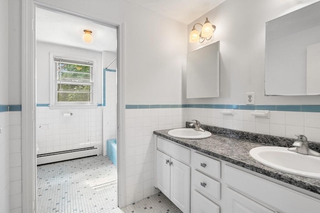 3 Biggar Ave, Wilmington, MA 01887 - full bath with a baseboard radiator, tile walls, double vanity, a wainscoted wall, and shower / tub combination